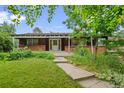 Charming single-story home with brick accents, a covered porch, and a well-maintained front yard at 7350 Field St, Arvada, CO 80005