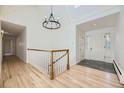 Bright foyer with hardwood floors, a skylight, and white trim with leaded glass sidelights at 2991 S Fillmore Way, Denver, CO 80210