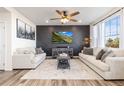Elegant living room with stylish accent wall, modern furnishings, and lots of natural light at 26361 E 5Th Pl, Aurora, CO 80018