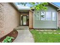 Inviting front entrance showcasing a brick facade, landscaped garden, and well-lit porch at 915 S Mckinley Ave, Fort Lupton, CO 80621