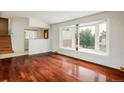 Bright living room features hardwood floors and a large bay window at 7210 Otis Ct, Arvada, CO 80003