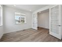 Bright office space featuring a large window and elegant French doors for privacy at 1376 Lumber Ridge N Cir, Erie, CO 80516