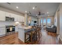 Open kitchen and living area with a kitchen island and barstool seating and sliding door to the balcony at 420 E Fremont Pl # 203, Centennial, CO 80122