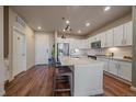 A well-lit kitchen showcasing an island, stainless steel appliances, and white cabinetry at 420 E Fremont Pl # 203, Centennial, CO 80122