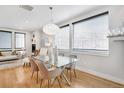 Open concept dining area with glass table and modern chairs at 3026 Zuni St, Denver, CO 80211