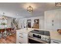 Modern kitchen with stainless steel appliances, quartz countertops, and a breakfast bar with seating at 3434 S Race St, Englewood, CO 80113
