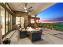Relaxing outdoor patio with comfortable seating, a fire pit, and stunning golf course views at 2932 Heron Lakes Pkwy, Berthoud, CO 80513