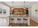 Open kitchen featuring a large island with pendant lighting and modern appliances at 7812 Blue Water Ln, Castle Rock, CO 80108