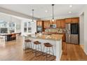 Spacious kitchen island with bar stool seating and open layout to a dining area at 7812 Blue Water Ln, Castle Rock, CO 80108