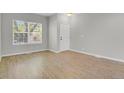 Inviting living room featuring new vinyl floors, neutral paint, and ample natural light at 9690 Lansing Cir, Commerce City, CO 80022