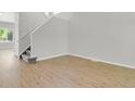 Bright, open living room with new vinyl floors and staircase at 9690 Lansing Cir, Commerce City, CO 80022