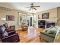 Cozy living room with a fireplace, hardwood floors, and sliding glass doors to the outside at 1038 Petras St, Erie, CO 80516