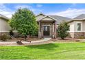 Landscaped front yard with stone pathway leading to entry at 17155 Primrose Ln, Mead, CO 80542