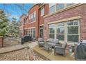 Charming red brick townhome with a cozy outdoor patio and seating area at 8977 E Otero Pl, Centennial, CO 80112