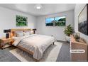 Calming bedroom with natural light, plush rug, neutral décor, and comfortable furnishings. (Virtually Staged) at 10371 Monterey Cir, Northglenn, CO 80260