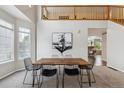 Dining room with tall ceilings, a modern table, and abundant natural light at 6519 Eastview St, Longmont, CO 80504