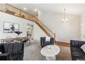Spacious living room featuring tall ceilings, staircase, and contemporary decor at 6519 Eastview St, Longmont, CO 80504