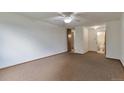 Spacious bedroom showcasing neutral carpet with access to an adjoining bathroom at 9340 E Center Ave # 8A, Denver, CO 80247