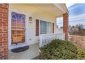 Inviting front porch with decorative details, featuring a sturdy railing and brick column at 20764 E 47Th Ave, Denver, CO 80249