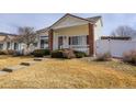 A charming home with a manicured lawn and a welcoming front porch at 20764 E 47Th Ave, Denver, CO 80249