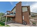 Backyard view featuring a brick chimney, a raised wood deck, and outdoor seating at 3254 Red Tree Pl, Castle Rock, CO 80104