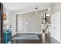 Bright foyer with modern wainscoting, dark hardwood floors, and a staircase leading to the upper level at 5752 S Jasmine St, Greenwood Village, CO 80111
