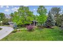 Well-maintained home with lush lawn, mature trees and colorful landscaping at 5752 S Jasmine St, Greenwood Village, CO 80111