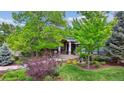 Charming home exterior with manicured front yard, mature trees, and inviting entryway at 5752 S Jasmine St, Greenwood Village, CO 80111