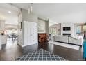 Open-concept living room featuring hardwood floors, a stone fireplace and ample natural light at 5752 S Jasmine St, Greenwood Village, CO 80111