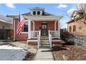 Inviting front porch with classic columns and a clear view of the home's facade at 2919 N York St, Denver, CO 80205