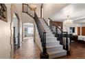 Grand foyer featuring a staircase with dark wood trim, high ceilings, and a decorative chandelier at 1930 E 8Th Ave, Denver, CO 80206