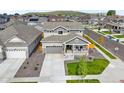This stunning aerial view showcases the neighborhood setting and home with a two-car garage at 17765 Faraday St, Broomfield, CO 80023