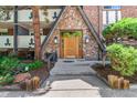 Charming entryway with stone facade and wooden door framed by decorative glass sidelights at 1260 York St # 204, Denver, CO 80206