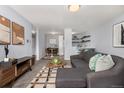 Inviting living room featuring a comfortable gray sectional sofa, stylish decor, and an open layout at 1260 York St # 204, Denver, CO 80206