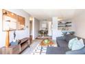 Charming living room with neutral tones, stylish furniture, and an open layout to the dining area and kitchen at 1260 York St # 204, Denver, CO 80206