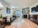 Inviting living room with a stone fireplace, modern decor, and a sliding glass door at 8335 Fairmount Dr # 11-203, Denver, CO 80247