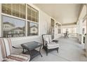 Relaxing front porch featuring comfortable seating with a table, great for enjoying the outdoors at 8977 Crossington Way, Lone Tree, CO 80124