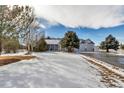 House exterior showcasing a charming front porch and landscaping, perfect for curb appeal at 6460 E 165Th Ct, Brighton, CO 80602