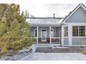 Two-story home with a welcoming front porch and beautiful landscaping at 6460 E 165Th Ct, Brighton, CO 80602