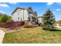 Well-landscaped front yard with vibrant bushes and a charming covered porch at 24394 E Dorado Pl, Aurora, CO 80016