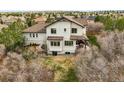 Aerial view of the back of the house showing the patio and backyard at 947 Buffalo Ridge Rd, Castle Pines, CO 80108