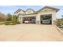 Spacious three car garage with room for multiple vehicles, shelving, and storage at 947 Buffalo Ridge Rd, Castle Pines, CO 80108