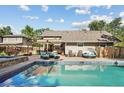 Backyard features a beautiful in-ground pool, lounge chairs, and pergola, perfect for outdoor entertaining at 751 Poplar St, Denver, CO 80220
