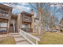 Exterior view of townhome featuring two levels with private balconies and a stone chimney at 1795 S Pitkin St # B, Aurora, CO 80017