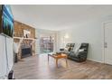 Comfortable living area with stone fireplace, sliding glass doors and modern furnishings at 1795 S Pitkin St # B, Aurora, CO 80017