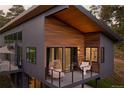 Stylish balcony furnished with cozy seating and offering views of a serene, wooded landscape at 20525 Flint Ln, Morrison, CO 80465
