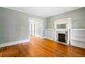 Bright living room boasts hardwood floors, decorative fireplace with built-in shelving at 130 S Humboldt St, Denver, CO 80209