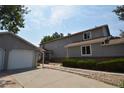 Gray townhouse exterior with a long driveway and attached garage at 522 W Crestline Cir # 8A3, Littleton, CO 80120