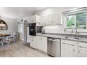 Updated kitchen with stainless steel appliances, sleek countertops, and tile backsplash at 6410 Independence Way, Arvada, CO 80004
