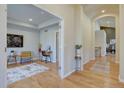 Bright hallway with hardwood floors leading to a living area, with an arched opening at 13941 E Whitaker Dr, Aurora, CO 80015